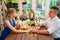 Loving couple sitting at table and holding hands