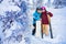 Loving couple skier and snowboarder hugging against background of winter forest and snow