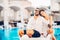 Loving couple spending vacation on tropical resort swimming pool.Newlyweds honeymoon on seaside