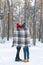 Loving couple standing in winter park under warm blanket. Tenderness, unity and love Back view