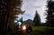 Loving couple surrounded by friends at an evening camping in the mountains.