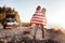 Loving couple traveling wrapping their bodies in national flag