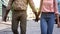 Loving couple walking holding hands, newlyweds vacation, active leisure, tourism