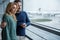 Loving couple watching plane tacking off