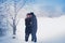 A loving couple on a winter walk. Snow love story, winter magic. Man and woman on the frosty street. The guy and the girl are rest