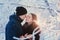 A loving couple on a winter walk. Snow love story, winter magic. Man and woman on the frosty street. The guy and the girl are rest