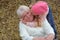 Loving cute granddaughter kissing her grandmother. Having good times with grandparent outdoors