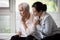 Loving daughter embracing comforting and consoling the old elderly, depressed stressed senior woman contemplating,afraid and