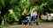 A loving daughter with her senior mother in a wheelchair, having a conversation while relaxing in a park. Woman taking