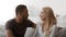 Loving Diverse Couple Talking Sitting On Sofa At Home