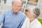 Loving elderly couple smiling at each other