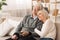 Loving Elderly Couple Watching TV, Resting At Home