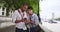 Loving ethnic couple using smartphone together outside in London