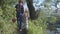 Loving family grandparents with their cute grandchild in hats have fun walking outdoors among trees