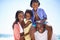 Loving family have a great time on the beach. An african american family enjoying a day out on the beach.