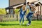 Loving father carrying daughter and playing football with family