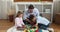 Loving father play wooden bricks with preschool son and daughter