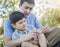 Loving Father Puts Bandage on Knee of Young Son