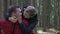 Loving girlfriend jumping on the boyfriend back kissing and caressing him while they enjoying the excursion in the nature -