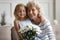 Loving grandchild make surprise greeting granny at home