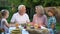 Loving grandchildren visiting grandparents, happy senior couple admiring kids