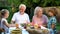 Loving grandchildren visiting grandparents, happy senior couple admiring kids