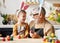 Loving grandfather and child in bunny ear headbands decorating eggs for Easter in light cozy kitchen