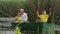 loving grandfather teaches his grandchildren to fish, family in boat near the reeds has fun together on summer holidays