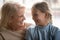 Loving grandmother looks at little granddaughter close up image