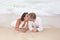 Loving groom kissing bride\'s mouth on beach