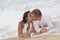 Loving groom kissing bride\'s mouth on beach