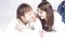 Loving Happy Couple Posing With Heads Turned to Each Other And Connected Hands With Positive Emotions On White Background