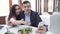 Loving happy couple in restaurant lays a ridiculous selfie in instagram through an iPhone slow motion stock footage