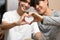 Loving homosexual couple making heart with hands and smiling to camera. LGBT, relationships and equality concept
