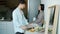 Loving husband cooking food and feeding wife beautiful Asian woman in kitchen in apartment