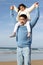 Loving Japanese family walking on beach