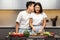 Loving Japanese Husband Kissing Wife Preparing Dinner Together In Kitchen