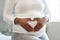 Loving the journey of motherhood. Closeup shot of an unrecognisable woman making a heart shape with her hands on her