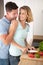 loving joyful couple embracing and cooking together