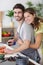 loving joyful young couple embracing and cooking together