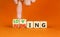 Loving or judging symbol. Concept words Loving or Judging on wooden cubes. Businessman hand. Beautiful orange table orange