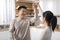 Loving korean spouses dancing waltz at kitchen