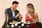 Loving man making proposal to girlfriend on romantic date in restaurant
