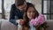 Loving man presenting bouquet of flowers to wife at home in slow motion.