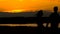 Loving man and woman silhouettes, walking at sunset