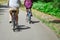 Loving married couple riding on bicycles. A man in beige shorts and a woman in a purple shirt. View from the back. Bike ride