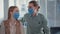 loving married couple wearing medical masks on their face while receiving patients in doctors office, smiling and