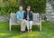 Loving married senior couple sitting together on a wooden bench in the Garden of the Villa Cipressi in Varenna.