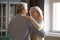 Loving mature couple dancing together celebrating at home