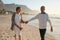 Loving mature couple strolling on the beach.